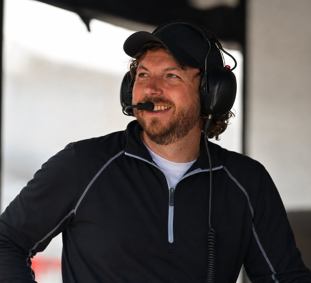 PocketStrainer's founder on the pit wall wearing a race-engineering headset